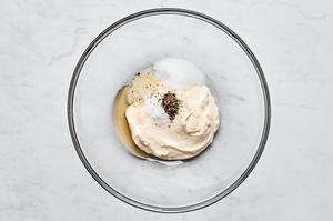 mayo, honey, sugar, onion powder, pepper and salt being whisked together in a bowl