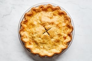 a Meat Pie with perfectly golden, flaky crust filled with a savory meat and potato filling with ground beef and pork