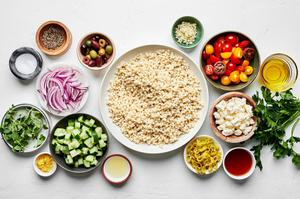 couscous, feta, Greek olives, cucumber, tomato, pepperoncini, red onion olive oil, red wine vinegar, spices and parsley