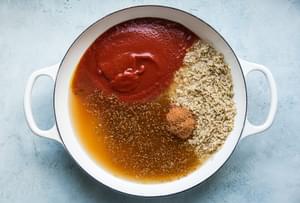 chicken stock, brown rice, taco seasoning tomato sauce in a pot