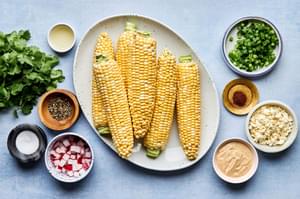 corn, radishes, green onions, cilantro, cotija, lime juice, salt, pepper and chipotle mayo in prep bowls