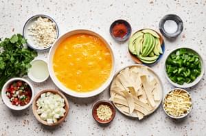 oil, corn tortillas, onion, bell pepper, garlic, eggs, salt, chili powder, cilantro, jack & cotija cheeses in prep bowls
