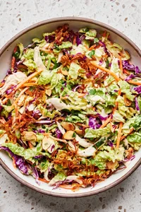 miso-ginger chicken slaw made with cabbage, almonds, cilantro, carrots, green onion, sesame oil, vinegar and spices