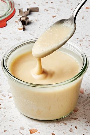 a bowl of miso ginger dressing made with miso, vegetable oil, vinegar, salt, sesame oil, honey, ginger, garlic and water