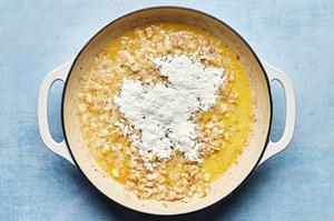 shallots, garlic, butter and flour being cooked together in a skillet