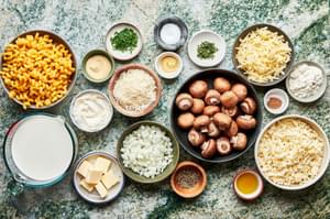 macaroni, mushrooms, onions, olive oil, butter, dijon, spices and cheeses in prep bowls