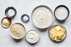 flour, baking powder, baking soda, salt, sugar, butter, yogurt and quick oats in prep bowls to make oat scones