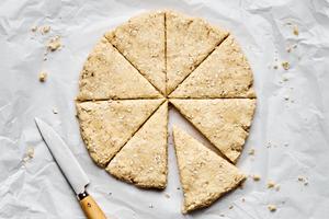 homemade oat scone dough shaped in to a circle being cut into triangles