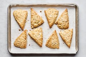 baked oat scones fresh out of the oven on a parchment lined baking sheet