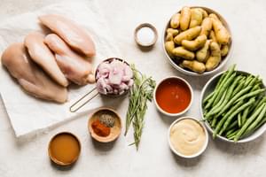 shallots, green beans, fingerling potatoes, raw chicken breast, honey and mustard in prep bowls