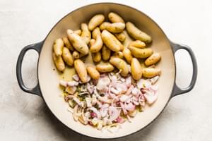 shallots and potatoes in a roasting dish