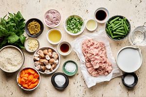 chicken, basil, garlic, green onions, fish sauce, curry paste, sugar, cornstarch, salt, green beans, carrots & rice in bowls