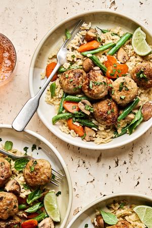 One Pot Chicken Meatball and Green Curry Rice being served into bowls