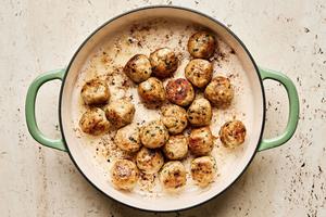 chicken meatballs being browned in a skillet
