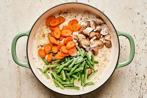 green beans, carrots and mushrooms being browned in olive oil and salt