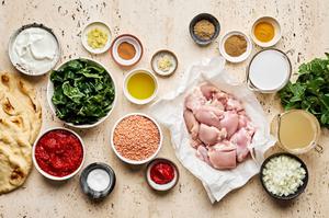 chicken thighs, onion, garlic, ginger, tomato paste, spices, stock, coconut milk, lentils and swiss chard in prep bowls