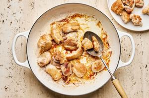 chicken thighs seasoned with salt being browned in a pan with olive oil