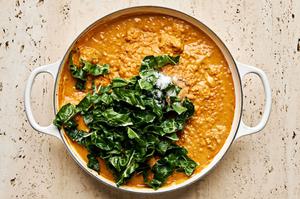 swiss chard added to a braised with one pot chicken and lentils
