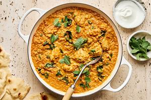 a pot of one pot chicken and lentils featuring tender chicken simmered with lentils & aromatic herbs topped with fresh mint