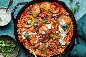 one pot chicken and rice in a skillet topped with homemade herb yogurt
