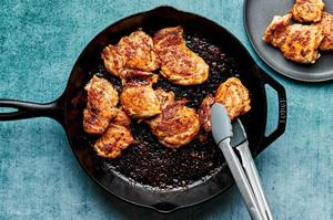chicken thighs seasoned with salt, smoked paprika, chili powder, brown sugar and black pepper being cooked in a skillet