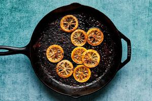 lemon slices being cooked in olive oil in a skillet until caramelized