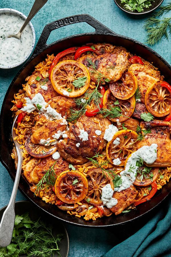 one pot chicken and rice made with chicken thighs, shallots, bell peppers, spices and jasmine rice topped with herb yogurt