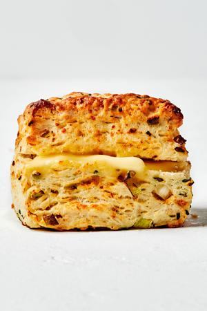 a homemade fluffy onion chive biscuit on the counter