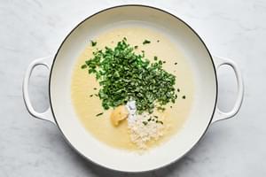 butter, garlic, parmesan cheese, tarragon, parsley, and salt cooking in a skillet