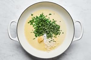 butter, garlic, parmesan cheese, tarragon, parsley, and salt cooking in a skillet