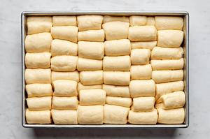 homemade parker house rolls on a baking sheet