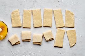 parker house rolls dough cut into small rectangles brushed with melted butter then folded in half