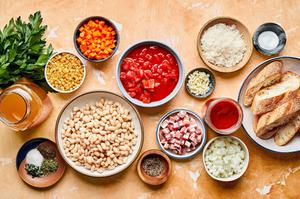 pancetta, cannellini beans, diced tomatoes, tomato sauce, stock, onions, garlic, spices, parmesan and bread in prep bowls