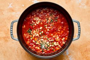 homemade pasta e fagioli soup with pancetta, cannellini beans and pasta noodles cooking in a pot