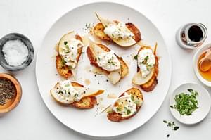 Pear and Burrata Crostini drizzled with sherry vinegar and honey and sprinkled with thyme, salt and pepper