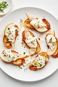 Pear and Burrata Crostini drizzled with sherry vinegar and honey and sprinkled with thyme, salt and pepper