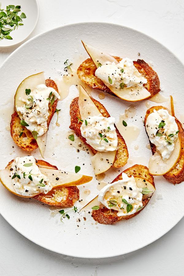 Pear and Burrata Crostini drizzled with sherry vinegar and honey and sprinkled with thyme, salt and pepper