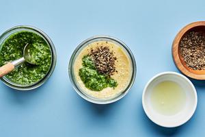 egg yolks, anchovies, garlic, salt, lemon juice, olive oil, pepper and pesto in a glass jar  to make pesto Caesar dressing