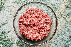 beef, egg, Worcestershire, rice, garlic, Italian seasoning, garlic powder, onion powder, salt, pepper & water mixed in a bowl