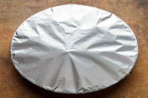 a baking dish of potato leek au gratin covered in foil ready to go in the oven