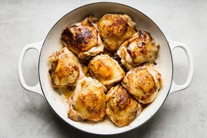 8 bone in skin on chicken thighs seasoned with salt and pepper browned in olive oil in a pan