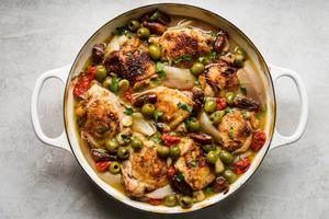 a pan of homemade chicken Provençal with olives, tomatoes, shallots, and white wine