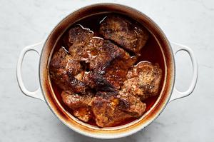 boneless pork shoulder, spices, apple cider vinegar and chicken stock cooking in a pot