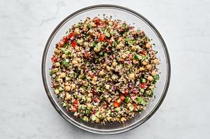 Homemade quinoa salad made with basil, garlic, chick peas, red onion, cucumber, tomato, bell pepper, jalapeño and parsley