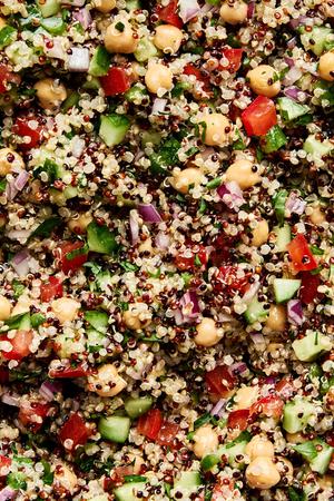 Homemade quinoa salad made with basil, garlic, chick peas, red onion, cucumber, tomato, bell pepper, jalapeño and parsley