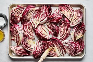 radicchio wedges on a sheet pan, brushed with olive oil and seasoned with salt