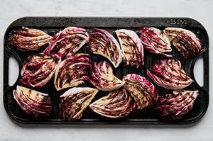 radicchio wedges brushed with olive oil and seasoned with salt being cooked on a grilled pan