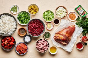 ingredients for homemade red beans rice in prep bowls andouille and hot louisiana sausage, ham hock, peppers, onions & spices