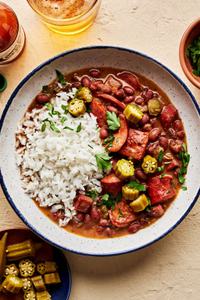 a bowl of homemade red beans rice made with andouille and hot louisiana sausage, ham hock, peppers, onions and spices