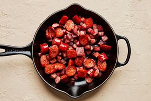 andouille and hot louisiana sausage, being cooked in a skillet